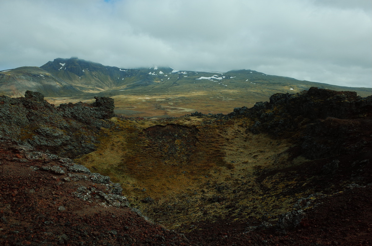 A side view of the wide bowl of the Saxholl Crater in Iceland.