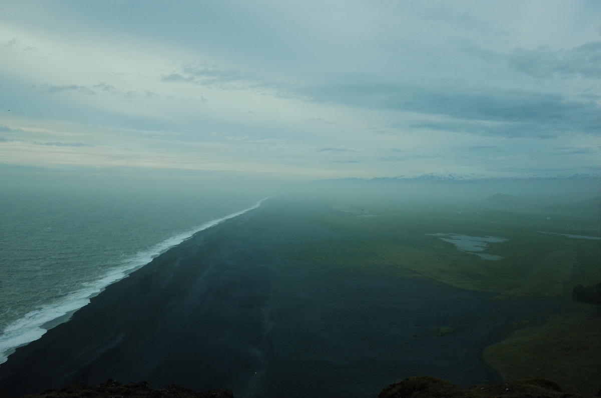 Black sand coast line stretching into the distance.