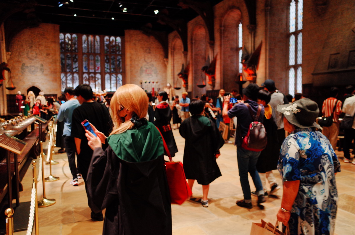 Guests within a recreation of Hogwart's Great Hall.