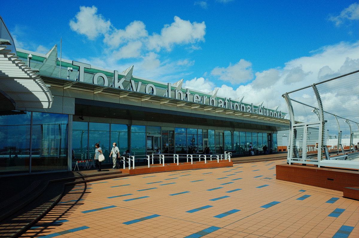 An outdoor patio with a sign which reads Tokyo International Airport.