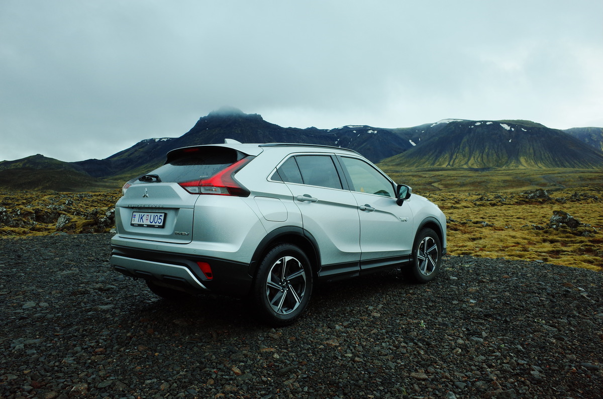 A silver car with distant mountains in background.