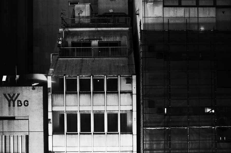 Darkened buildings inside of Akihabara, Japan.