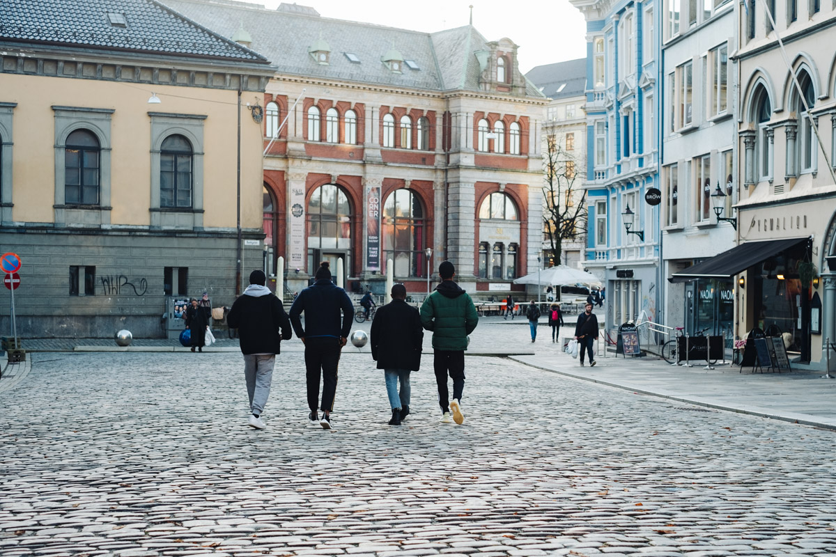 Four men walking in Bergen, Norway.