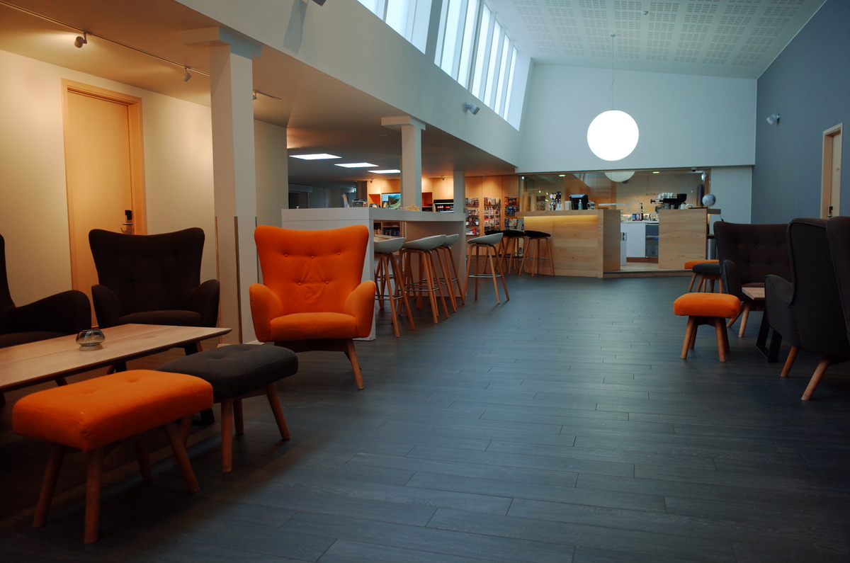 Empty chairs and stools within the lobby of Rejykvaik Lights.