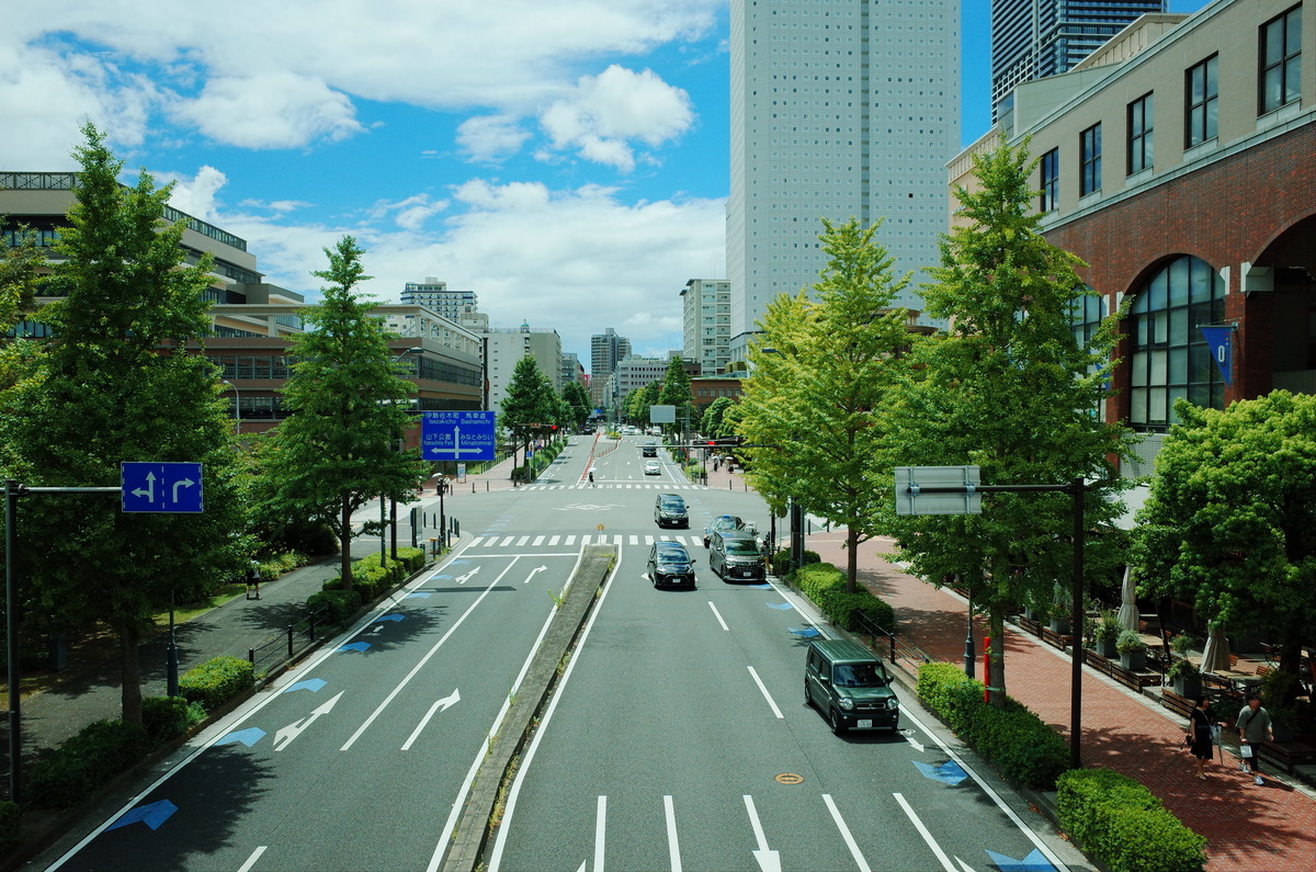 A city block in Yokohama, Japan, viewed from an overhead crosswalk.