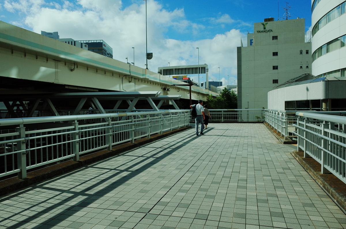 Two people on a crosswalk in Yokohama, Japan.